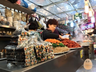 A common sight in Gwangjang Market. Just sit down and use your fingers to communicate!